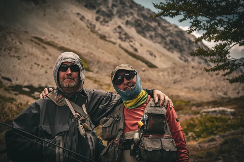 Two anglers arm in arm after a day on the water in Patagonia