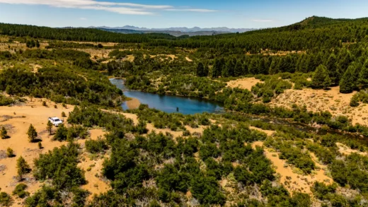 Wide Patagonian valley with a river winding through the steppe
