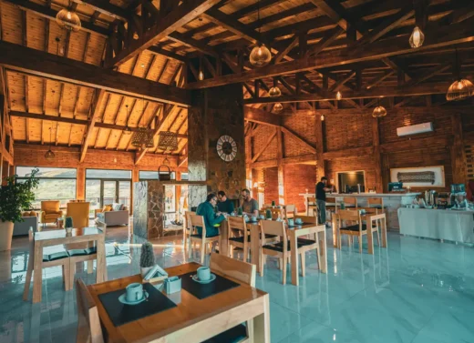 Dining room of a Patagonian lodge with tables set for dinner