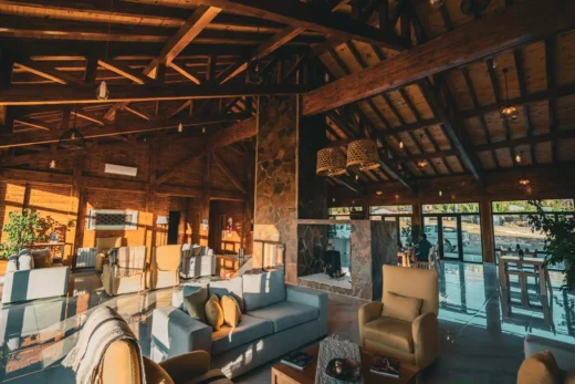 Lounge of a Patagonian lodge with armchairs and large windows