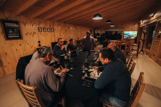 Group of anglers sharing dinner around a long table