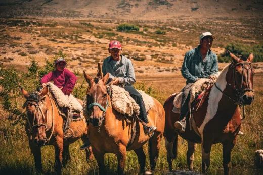 Young gauchos on horseback on the estancia at midday