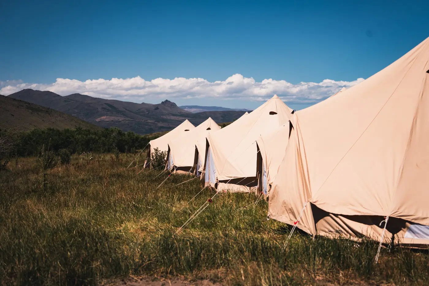 White tents of the mobile camp beside the river, northern Patagonia